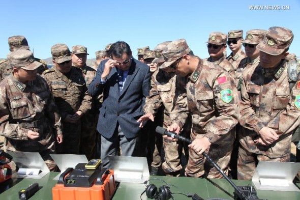 Mongolian side visit Chinese rescue equipment during the opening of a joint training for natural disaster relief at a training center in Tavan Tolgoi, Mongolia, Sept. 16, 2013. Chinese and Mongolian armed forces on Monday kicked off joint training for natural disaster relief. The eight-day training, code-named Prairie Pioneer, features joint training courses, discussion forums, simulation and field exercises. (Xinhua/Wang Ning)  