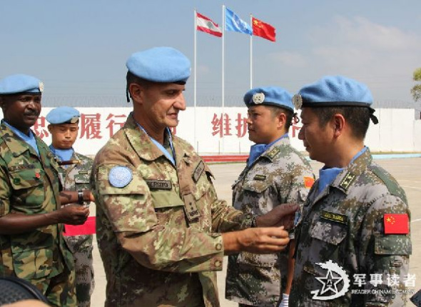 Yan Bin (R), Leader of the 10th Chinese peacekeeping medical detachment to Lebanon, is awarded the United Nations Medal of Peace by Maj. Gen. Paul Sierra (L), commander of the United Nations Interim Force in Lebanon (UNIFIL). Recently, 60 peacekeeping officers and men of the 10th Chinese peacekeeping medical detachment to Lebanon were awarded the United Nations Medals of Peace. (Chinamil.com.cn/ Yang Shengchao and Wang Qiang)