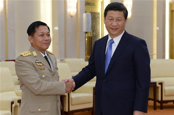 Chinese President Xi Jinping(R), who is also chairman of China's Central Military Commission, shakes hands with Myanmar's Commander-in-Chief of the Defense Services Senior-General Min Aung Hlaing during their meeting in Beijing, capital of China, Oct 16, 2013. [Photo/Xinhua]