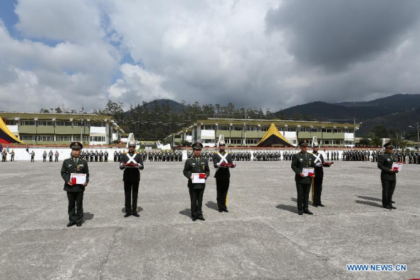 Four members of the Seventh Chinese medical aid team in Ecuador take part in the ceremony of receiving The Star of the Armed Forces medals in Quito, Ecuador, Oct. 31, 2013. Ecuador's military Thursday conferred its highest honor on four Chinese medical aid workers, Zhang Guolong, Ma Baojia, Gao Changming and Li Chunpeng, recognizing their great contribution. (Xinhua/Hao Yunfu)