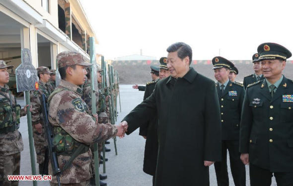 Chinese President Xi Jinping (C), also general secretary of the Communist Party of China (CPC) Central Committee and chairman of the Central Military Commission, shakes hands with a recruit after watching a shooting practice at the Jinan Military Area Command in Jinan, capital of east China's Shandong Province, Nov. 28, 2013. (Xinhua/Li Gang)