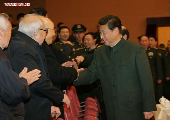Chinese President Xi Jinping (R, front), also general secretary of the Communist Party of China (CPC) Central Committee and chairman of the Central Military Commission, attends a festive art performance to extend Spring Festival greetings to military veterans and ex-officers in Beijing on Monday. (Xinhua/Li Gang)