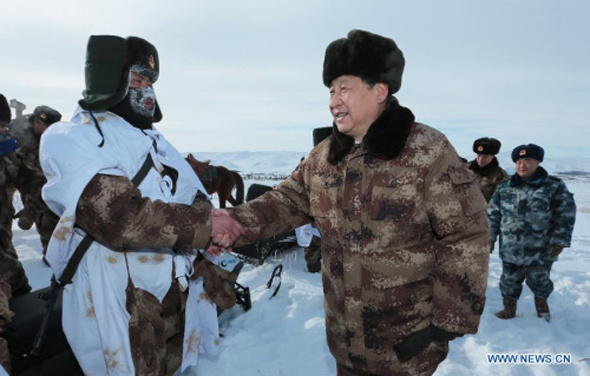 Chinese President Xi Jinping shakes hands with a soldier on patrol at the border line in Arxan of north China's Inner Mongolia Autonomous Region, Jan. 26, 2014. Xi visited soldiers stationed along the Chinese-Mongolian border ahead of the upcoming traditional Chinese New Year. (Xinhua/Li Gang)