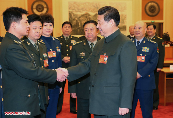 Chinese President Xi Jinping (front R), talks with a deputy to the 12th National People's Congress (NPC) from the People's Liberation Army (PLA) in Beijing, March 11, 2014. (Xinhua/Li Gang)