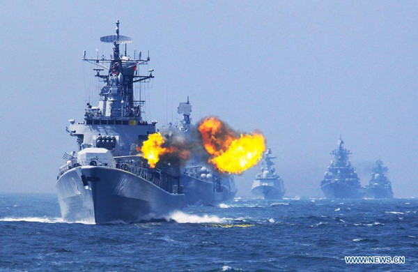China's Harbin missile destroyer fires at a target during the China-Russia joint naval drill on East China Sea, May 24, 2014. The three-day drill Joint Sea-2014 ended successfully on Saturday. The Chinese and Russian navies staged exercises, including joint escort drill, joint aircraft identification exercise and air defense and maritime assault drills. (Xinhua/Zha Chunming)