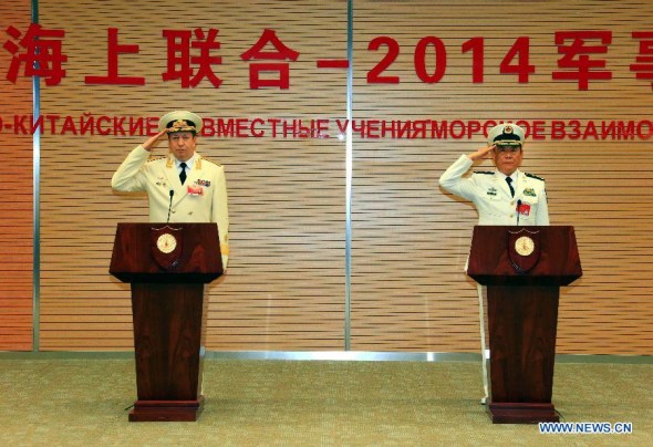 Tian Zhong (R), deputy commander of the Chinese Navy and the Chinese director of the Joint Sea-2014, and Fedotenkov, deputy commander of Russian Navy and Russian director of the drill, salute at the closing ceremony of the China-Russia joint naval drill in Shanghai, May 26, 2014. (Xinhua/Zha Chunming)