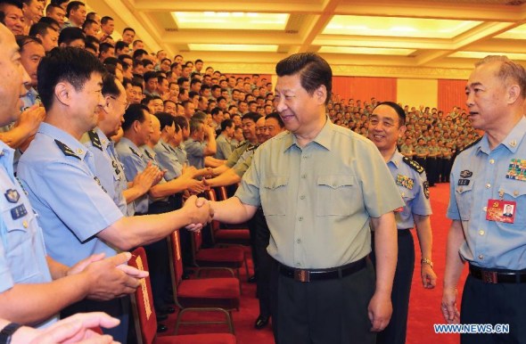 Chinese President Xi Jinping (C), also general secretary of the Communist Party of China (CPC) Central Committee and chairman of the Central Military Commission, meets with representatives attending the 12th CPC congress of the People's Liberation Army (PLA) Air Force in Beijing, capital of China, June 17, 2014. (Xinhua/Li Gang)