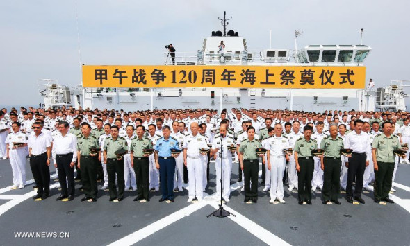Officers and soldiers of the People's Liberation Army (PLA) Navy mourn the Chinese navy soldiers killed in the First Sino-Japanese War of 1894-1895 on a ship in a port of Weihai, east China's Shandong province, Aug 27, 2014.   (Xinhua/Zha Chunming)