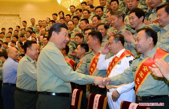 Chinese President Xi Jinping, also general secretary of the Communist Party of China (CPC) Central Committee and chairman of the Central Military Commission, shakes hands with delegates attending a meeting of chiefs of staff of the People's Liberation Army (PLA) in Beijing, capital of China, Sept 22, 2014. (Xinhua/Li Gang)