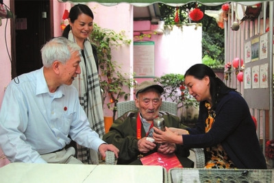 Staffs of the Beijing Zhiyuan Foundation for Concerning and Caring for Heroes extend their regards to the veterans who have participated in the Anti-Japanese War. (Beijing Times/Zheng Lei)