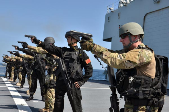 Officers from the Chinese and US navies demonstrate their shooting skills on Thursday when the two navies launched their latest anti-piracy exercise in the Gulf of Aden. SUN HAICHAO / XINHUA