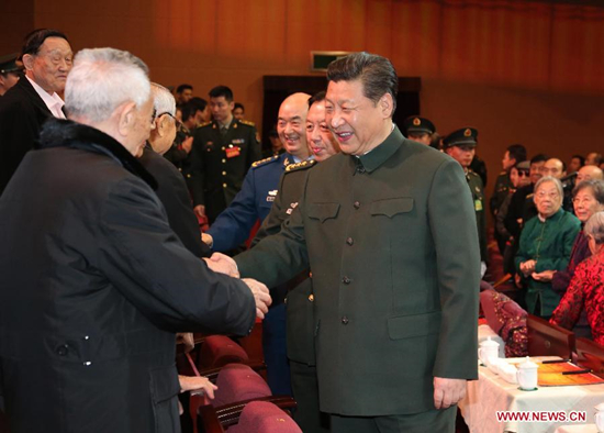 Chinese President Xi Jinping (R, front), also general secretary of the Communist Party of China (CPC) Central Committee and chairman of the Central Military Commission, attends a festive art performance to extend Spring Festival greetings to military veterans and ex-officers in Beijing, capital of China, Feb. 9, 2015. (Xinhua/Li Gang)