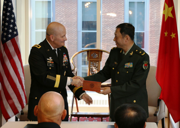 Major General Tang Ning, deputy chief for training of China's People's Liberation Army General Staff Department and Major General William Hix, deputy director of the U.S. Army Capabilities Integration Center, sign the China-U.S. Army-to Army Dialogue Mechanism at the National Defense University in Washington on Friday afternoon, under the witness of visiting Chinese Central Military Commission Vice-Chairman Fan Changlong and U.S. Army Chief of Staff Raymond Odierno. Chen Weihua/China Daily