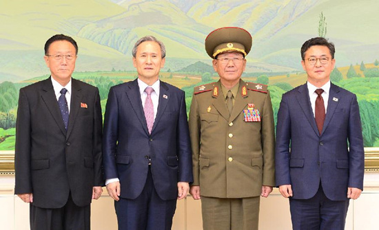 Kim Yang Gon, United Front Department Director of the Democratic People's Republic of Korea (DPRK), Kim Kwan-jin, chief of the National Security Office of South Korea, Hwang Pyong So, director of the General Political Bureau of the Korean People's Army of DPRK, and Unification Minister of South Korea Hong Yong-pyo, (L to R), pose for a photo after their talks at the Panmunjom truce village inside the demilitarized zone (DMZ) dividing the two Koreas, Aug. 25, 2015. (Photo/Xinhua)