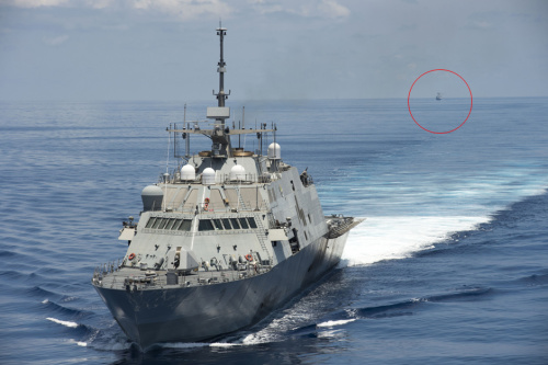 File photo of Chinese Navy fleet (front) keeps eye on U.S. fleet (circled) in South China Sea.