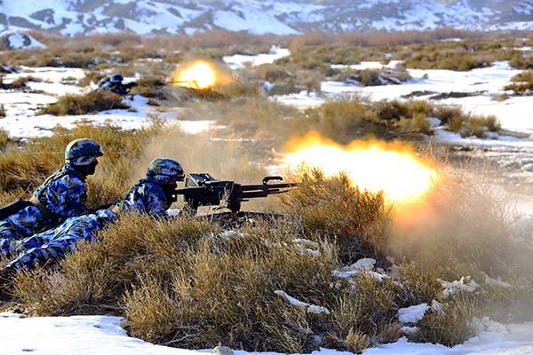 Heavy machine gunners from the PLA Navy Marine Corps take part in a live-fire drill held in the Xinjiang Uygur autonomous region on Friday. (Shi Jiamin/for China Daily)