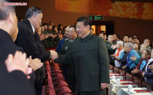 Chinese President Xi Jinping (R, front), also general secretary of the Communist Party of China (CPC) Central Committee and chairman of the Central Military Commission, extends Lunar New Year greetings to veterans during a concert for retired military officials and veterans in Beijing, capital of China, Jan. 28, 2016. (Photo: Xinhua/Li Gang)