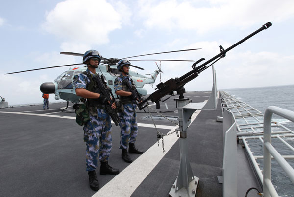 Chinese Navy soldiers observe from China's amphibious landing ship Changbaishan during an escort mission in the Gulf of Aden, Aug 26, 2014. (Photo/Xinhua)