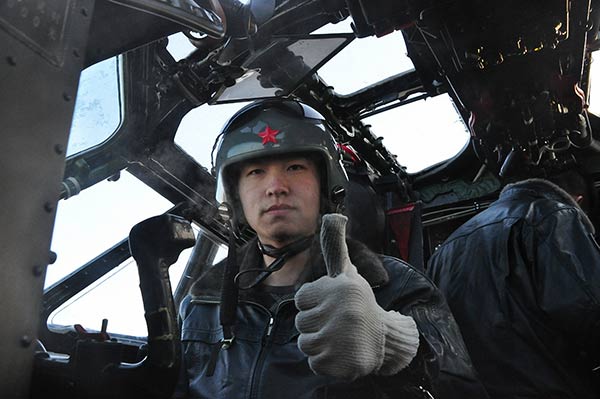 A pilot gives a thumbsup for takeoff at the Harbin Flight Academy of the PLA Air Force. Provided To China Daily