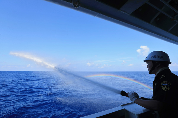 A crew member takes part in a fire drill on China's largest and most advanced patrol vessel Haixun 01 on the South China Sea, April 4, 2016. (Photo/Xinhua)