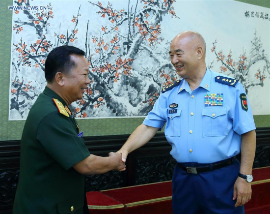 Xu Qiliang (R), vice chairman of China's Central Military Commission (CMC), meets with Lao Minister of Defense Lieutenant-General Chansamone Chanyalath in Beijing, capital of China, July 18, 2016. (Xinhua/Ding Haitao) 