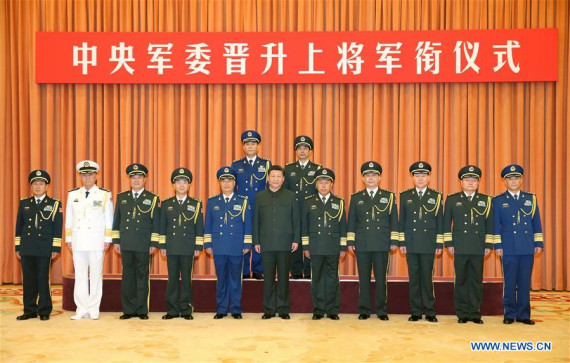 Chinese President Xi Jinping (C, front), who is also chairman of the Central Military Commission (CMC), and other military leaders pose for a group photo with two senior military officers, who are promoted to the rank of general, the highest rank for officers in active service, after a promotion ceremony in Beijing, capital of China, July 29, 2016. Xi Jinping presented the officers with certificates of command on Friday. (Photo: Xinhua/Li Gang)
