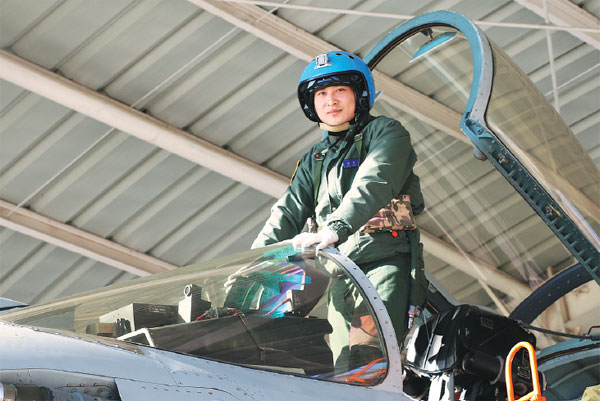 Pilot Zhang Chao poses for a photo before flying a J-15 