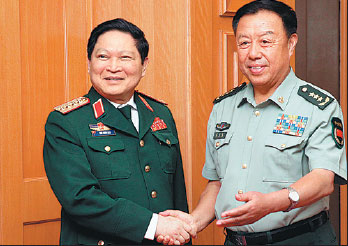 Fan Changlong (right), vice-chairman of the Central Military Commission, meets with Vietnamese Defense Minister Ngo Xuan Lich in Beijing on Monday. Song Jihe / For China Daily