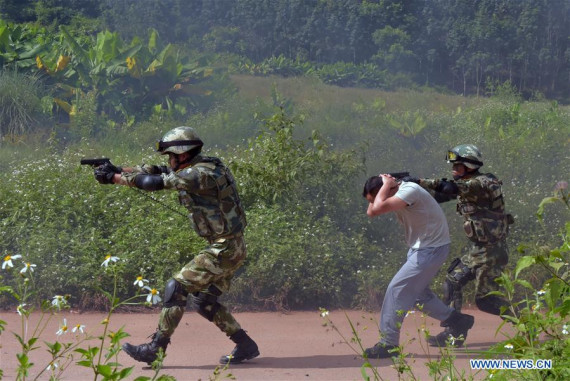 Police officers take part in a joint anti-terrorist exercise between Chinese and Laotian police in Xishuangbanna of southwest China's Yunnan Province, Sept. 13, 2016. A total of 280 police officers from Yunnan's Xishuangbanna prefecture and Luang Namtha Province of Laos participated in the 90-minute drill, which started at 10 a.m. on Tuesday. (Photo: Xinhua/Chen Haining)