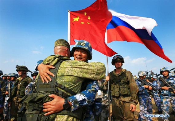 Chinese and Russian marines hug during a joint naval drill in Zhanjiang, south China's Guangdong Province, Sept. 14, 2016. (Photo: Xinhua/Zha Chunming)