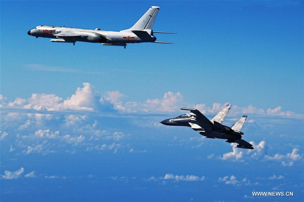 H-6K bombers and Su-30 fighters were among the 40 aircraft involved in the PLA Air Force's drill over the Western Pacific on Sunday. The drill was to test the military's far-offshore combat and assault capabilities.(Photo/Xinhua)