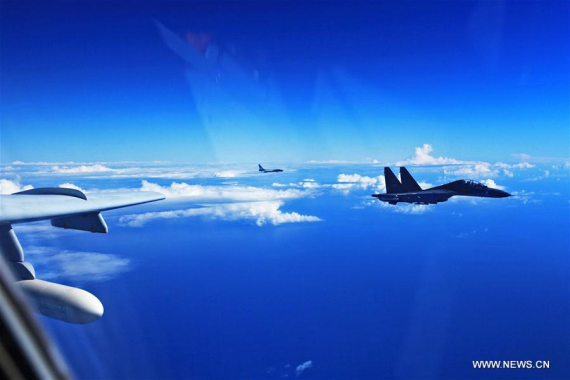 A Su-30 fighter and an H-6K bomber of the Chinese Air Force take part in a drill, Sept. 25, 2016. (Photo: Xinhua/Tian Ning)