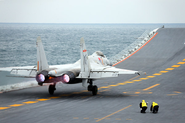 A J-15 fighter takes off from the Liaoning on Friday during a fleet training exercise in the Yellow Sea. Mo Xiaoliang/CHINA DAILY