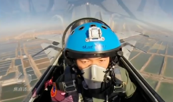 Still image of the video showing the words Shoot them! on a J-15 pilot's helmet. (Photo/CCTV)