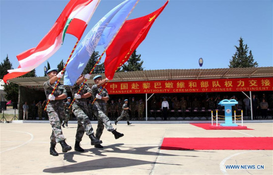 Three flag-bearers parade past the rostrum during the 15th CHINBATT Transfer of Authority (rotation) ceremony in the south Lebanese village of Hinnieh by the port city of Tyre, on May 22, 2017. (Xinhua/Li Liangyong)