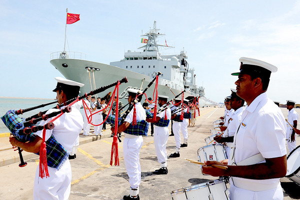 A Sri Lankan military band welcomes the arrival of a Chinese Navy fleet at a port in Colombo, the country's capital, on Wednesday. Shi Kuiji / For China Daily