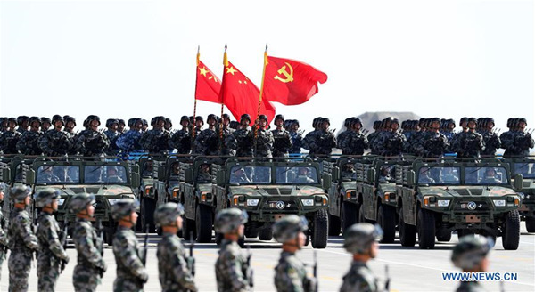 A flag guard formation consisting of officers and soldiers from the army, air force, navy and rocket force of the Chinese People's Liberation Army (PLA) attends a military parade to mark the 90th anniversary of the founding of the PLA at Zhurihe training base in North China's Inner Mongolia autonomous region, July 30, 2017.(Photo/Xinhua)