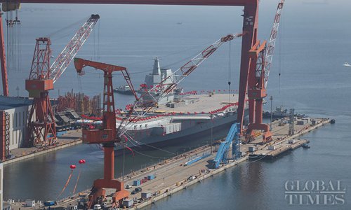 Chinas first domestically built aircraft carrier, decorated with red flags and colorful ribbons, prepares to launch from Dalian Port, Northeast Chinas Liaoning Province on April 26. (Photo: Cui Meng/GT)