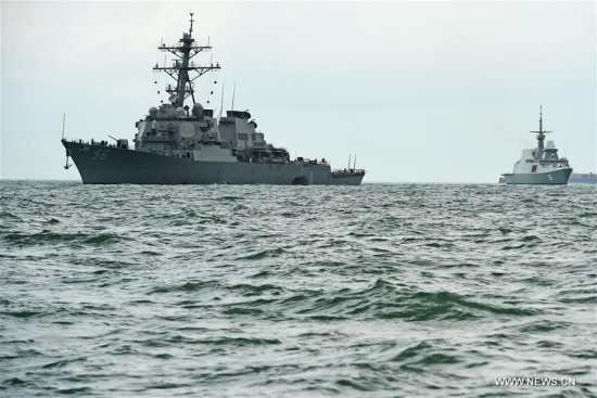 USS John S. McCain (L) is seen at sea off Singapore's Changi Naval Base, on Aug. 21, 2017. Ten sailors were missing and five others injured after the guided-missile destroyer USS John S. McCain collided with a merchant vessel in waters east of the Straits of Malacca and Singapore early on Monday, the U.S. navy said in a statement. (Xinhua/Then Chih Wey)