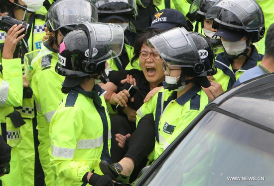 A protester clashes with the police during a demonstration against the Terminal High Altitude Area Defense (THAAD) in Seongju, South Korea, on Sept. 7, 2017. (Xinhua/Yao Qilin)