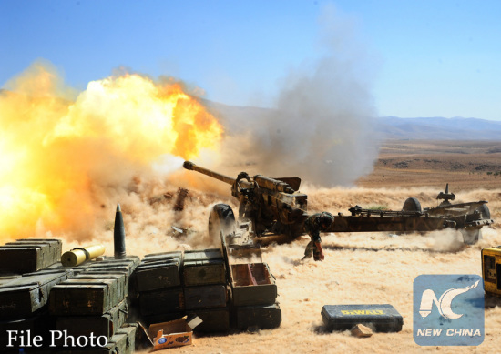 A Hezbollah fighter fires at a position of the Islamic State (IS) group in Syria's Qalamoun region, on Aug. 26, 2017. (Xinhua/Ammar Safarjalani)