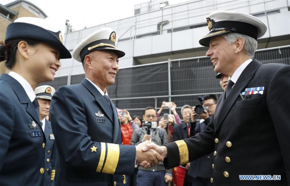 China's 26th naval escort fleet commander Wang Zhongcai (2nd L, Front) shakes hands with David Elford, British Naval Regional Commander for Eastern England, during a farewell ceremony at West India Docks in east London's Canary Wharf, Britain, on Oct. 7, 2017. (Xinhua/Han Yan)