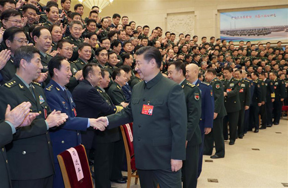 Xi Jinping, general secretary of the Communist Party of China (CPC) Central Committee, who is also Chinese president and chairman of the Central Military Commission, meets with delegates, specially invited delegates and non-voting participants of the 19th CPC National Congress from the People's Liberation Army (PLA) and the armed police forces before meeting senior military officers in Beijing, capital of China, Oct. 26, 2017. (Xinhua/Li Gang)