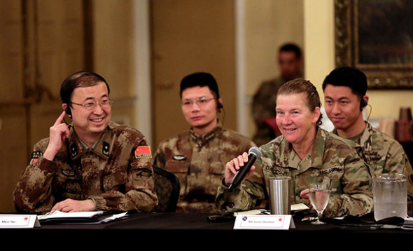 Major General Li Hui (left) of the Political Work Department of the Central Military Commission talks with US Army Major General Susan Davidson at a seminar, part of a joint humanitarian and disaster relief exercise in Portland, Oregon, on Monday. (YIN HANG/FOR CHINA DAILY)