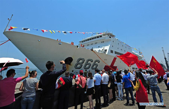 People welcome the arrival of Chinese naval hospital ship Peace Ark in Luanda, Angola, on Oct. 19, 2017.   (Xinhua/Jiang Shan)