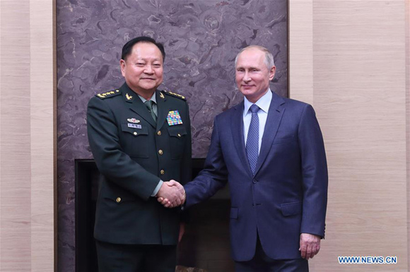 Russian President Vladimir Putin (R) meets with Zhang Youxia, a member of the Political Bureau of the Communist Party of China (CPC) Central Committee and vice chairman of the CPC Central Military Commission, in Moscow, Russia, on Dec. 7, 2017. (Xinhua/Li Xiaowei)