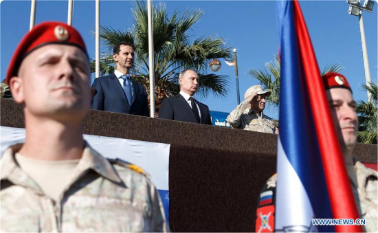 Syrian President Bashar al-Assad (1st L, Rear) and his Russian counterpart Vladimir Putin (2nd L, Rear) view a military parade in the Russian-run Hmeimim Air Base in the coastal city of Latakia, Syria, on Dec. 11, 2017.(Xinhua/Syrian Presidency)
