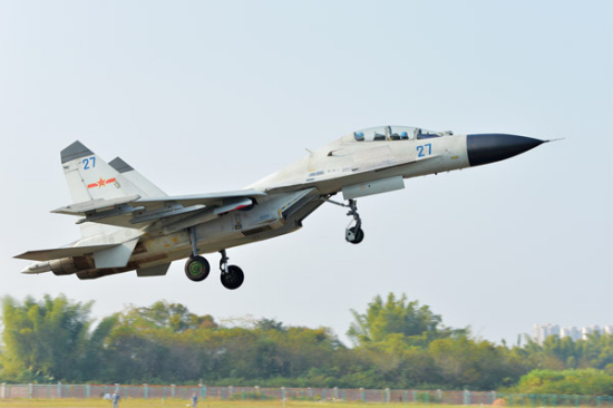 A fighter jet of the Navy's South Sea Fleet takes off from an unidentified air base this month to take part in a recent combat exercise over the western Pacific Ocean. (Photo by GAO HONGWEI/FOR CHINA DAILY)