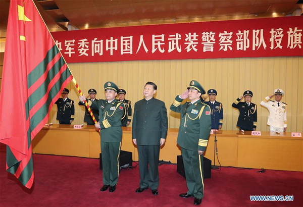 Chinese President Xi Jinping (C, front), also general secretary of the Communist Party of China (CPC) Central Committee and chairman of the Central Military Commission (CMC), confers the flag on the armed police force at a CMC ceremony in Beijing, capital of China, Jan. 10, 2018. (Xinhua/Li Gang)