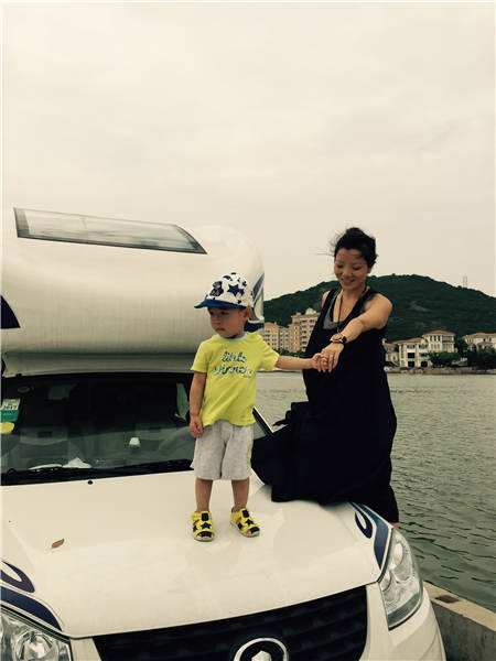 Fang Ling and her son with their family's recreational vehicle. Fang and her husband have traveled in the RV since 2014 when they started by taking their then-14-month-old boy to tour southern China in their new RV. Provided to China Daily